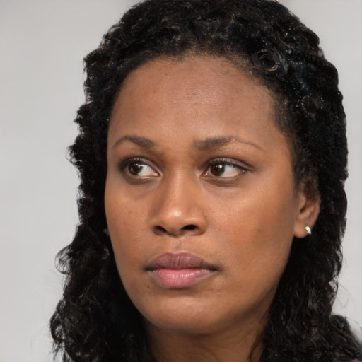 Neutral black young-adult female with long  black hair and brown eyes