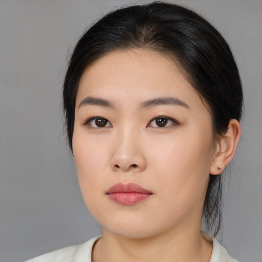 Neutral asian young-adult female with medium  brown hair and brown eyes