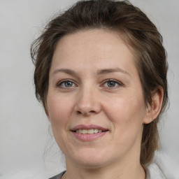 Joyful white adult female with medium  brown hair and brown eyes