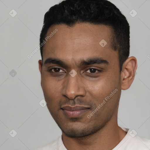 Joyful black young-adult male with short  black hair and brown eyes