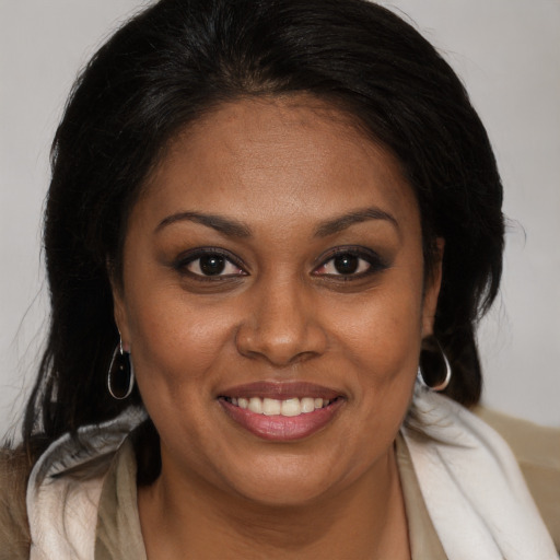 Joyful black young-adult female with medium  brown hair and brown eyes
