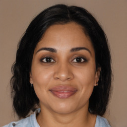 Joyful black young-adult female with medium  brown hair and brown eyes