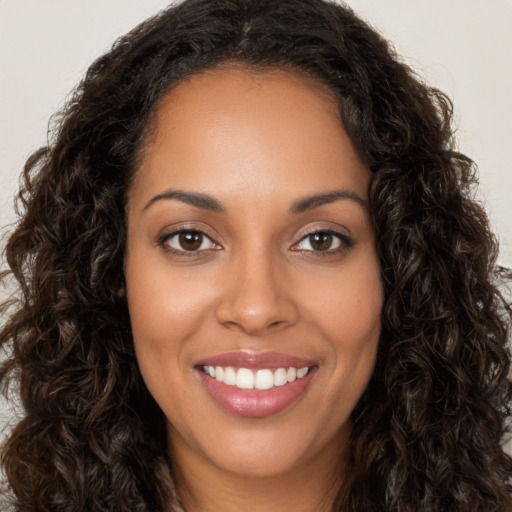 Joyful latino young-adult female with long  brown hair and brown eyes