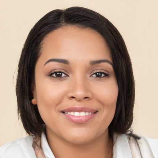 Joyful latino young-adult female with medium  brown hair and brown eyes