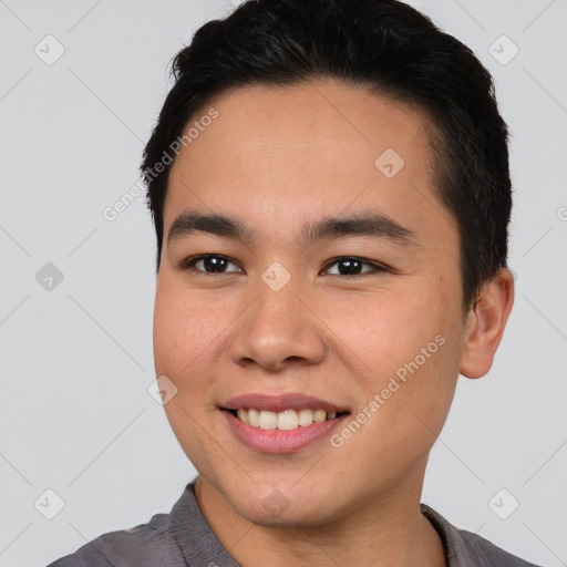 Joyful asian young-adult male with short  black hair and brown eyes