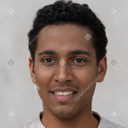 Joyful black young-adult male with short  black hair and brown eyes