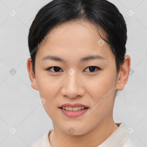 Joyful asian young-adult female with short  brown hair and brown eyes