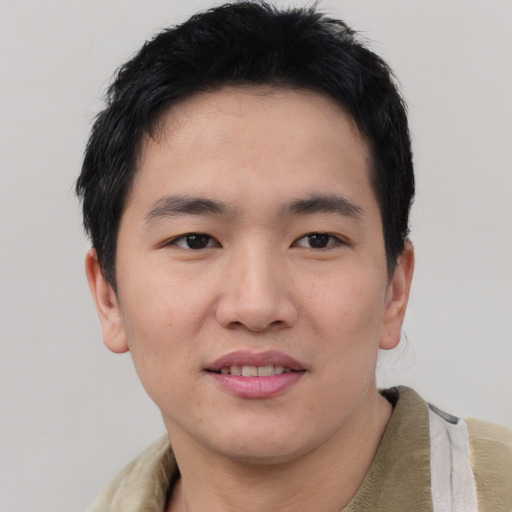 Joyful asian young-adult male with short  brown hair and brown eyes