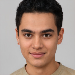 Joyful latino young-adult male with short  black hair and brown eyes