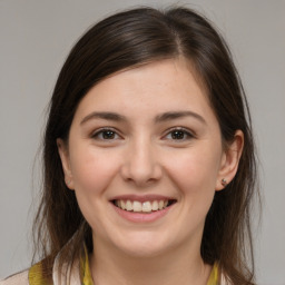 Joyful white young-adult female with medium  brown hair and brown eyes