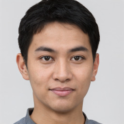 Joyful asian young-adult male with short  black hair and brown eyes