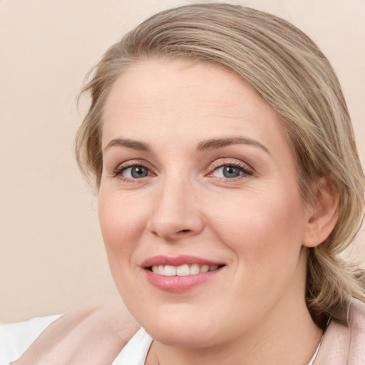 Joyful white young-adult female with medium  brown hair and blue eyes