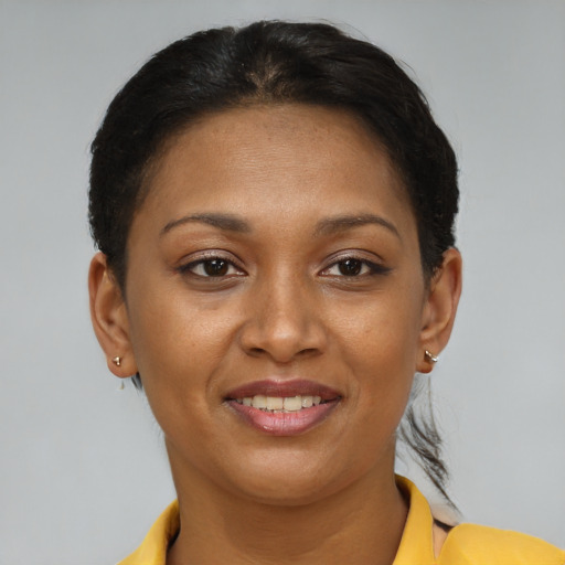 Joyful black young-adult female with short  brown hair and brown eyes