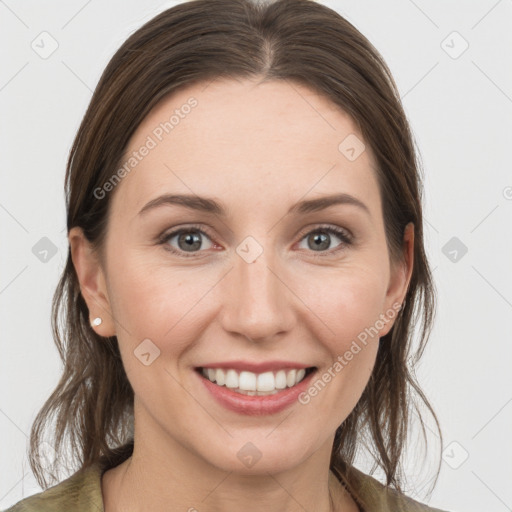 Joyful white young-adult female with medium  brown hair and grey eyes