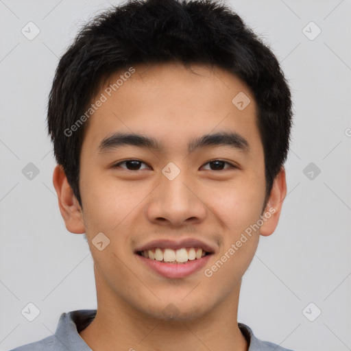 Joyful asian young-adult male with short  brown hair and brown eyes