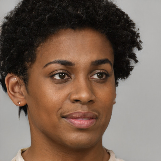 Joyful black young-adult female with short  brown hair and brown eyes
