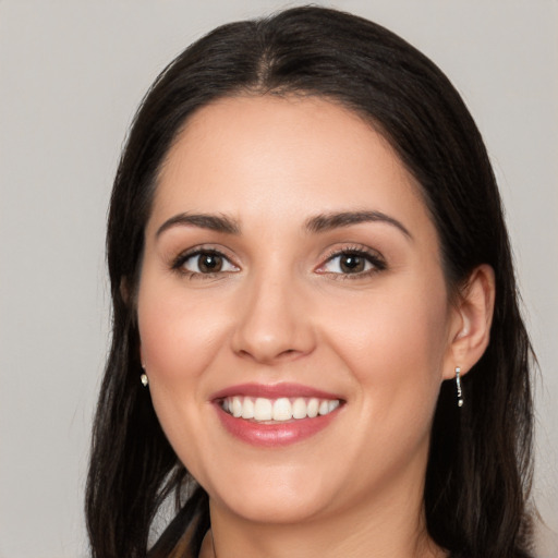 Joyful white young-adult female with long  black hair and brown eyes