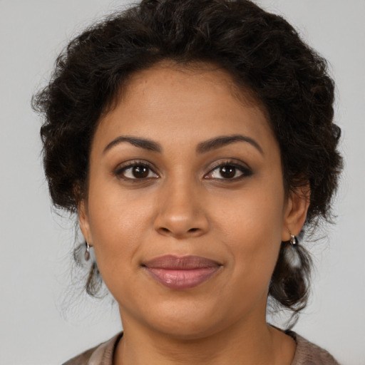 Joyful latino young-adult female with medium  brown hair and brown eyes