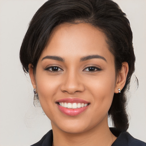 Joyful latino young-adult female with long  brown hair and brown eyes