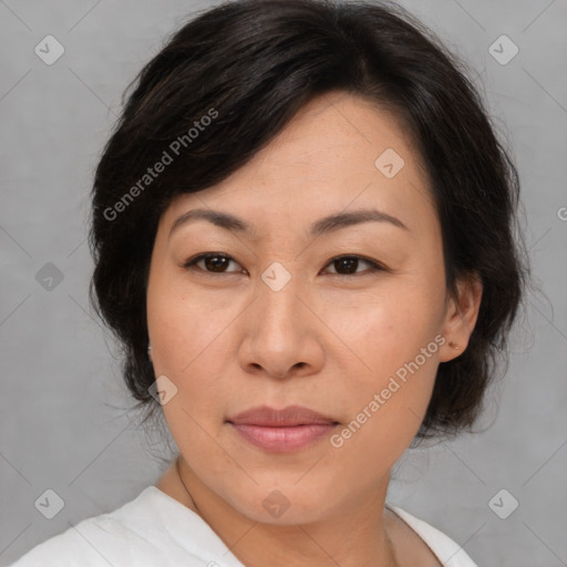 Joyful asian adult female with medium  brown hair and brown eyes