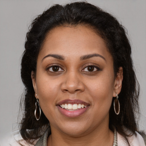 Joyful latino young-adult female with medium  brown hair and brown eyes