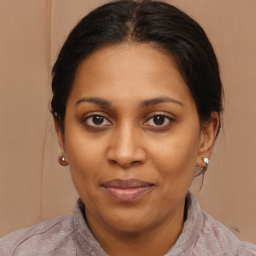 Joyful black young-adult female with medium  brown hair and brown eyes