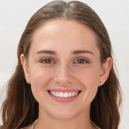 Joyful white young-adult female with long  brown hair and grey eyes