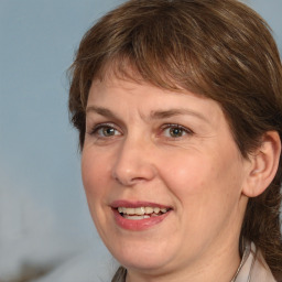 Joyful white adult female with medium  brown hair and grey eyes