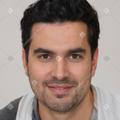 Joyful white young-adult male with short  black hair and brown eyes