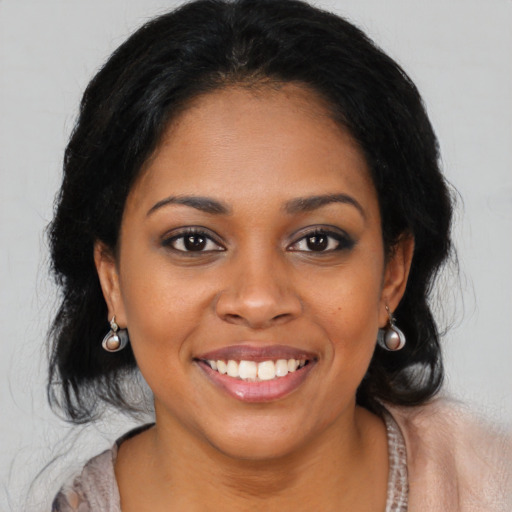 Joyful black young-adult female with medium  black hair and brown eyes