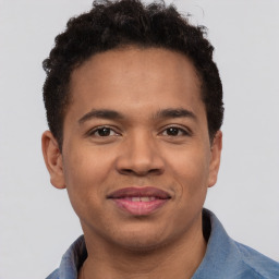 Joyful latino young-adult male with short  brown hair and brown eyes