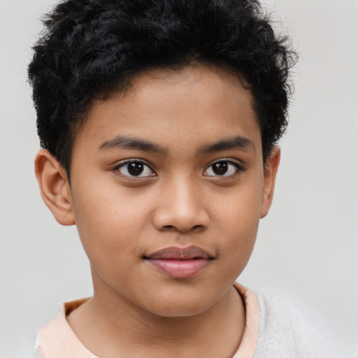 Joyful latino child male with short  brown hair and brown eyes