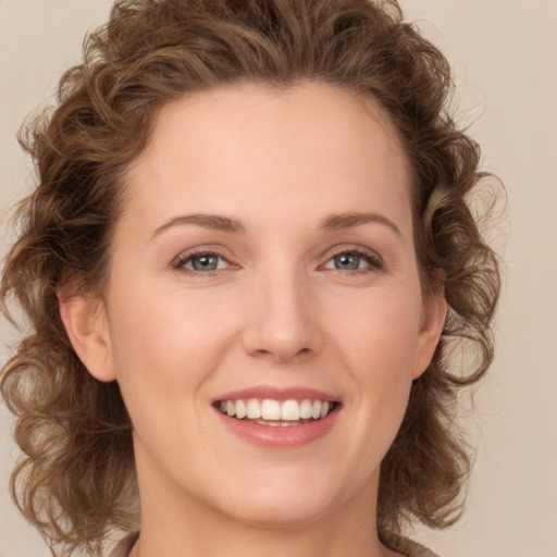 Joyful white young-adult female with medium  brown hair and green eyes