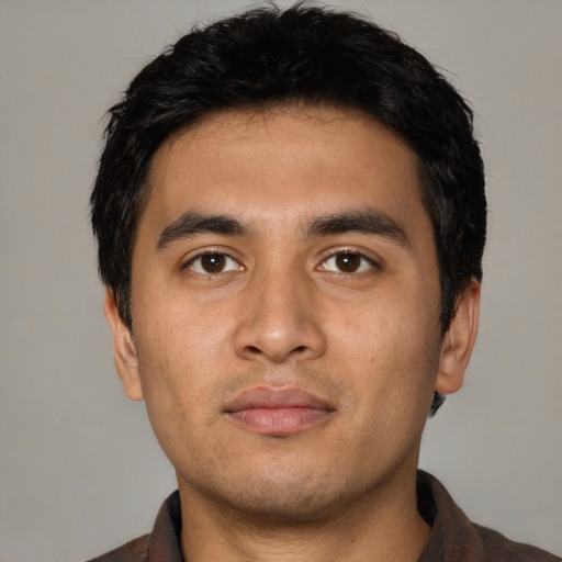 Neutral latino young-adult male with short  black hair and brown eyes