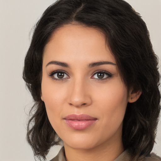 Joyful latino young-adult female with medium  brown hair and brown eyes