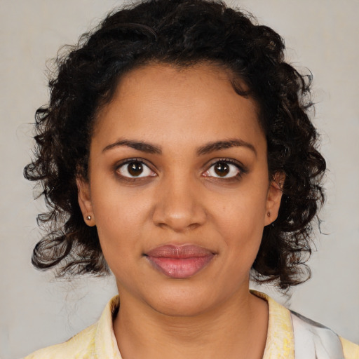 Joyful black young-adult female with medium  brown hair and brown eyes