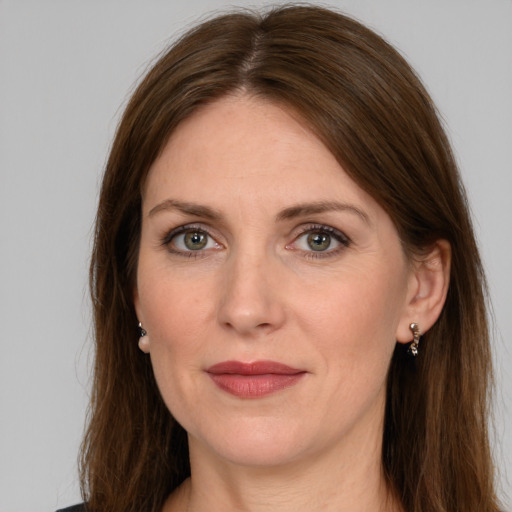 Joyful white adult female with long  brown hair and grey eyes