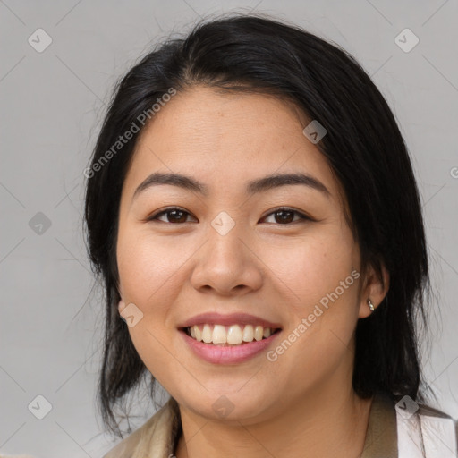 Joyful asian young-adult female with medium  black hair and brown eyes