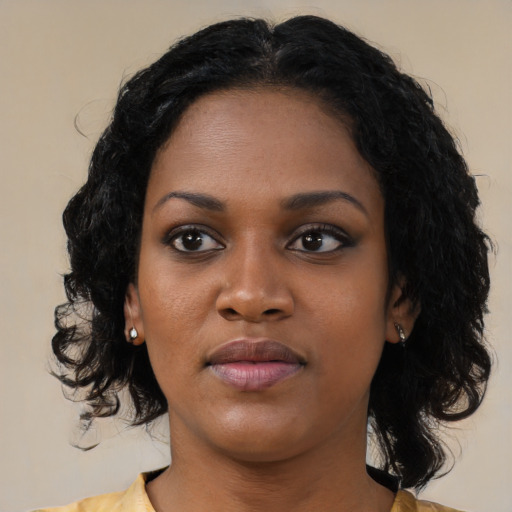 Joyful black young-adult female with medium  black hair and brown eyes