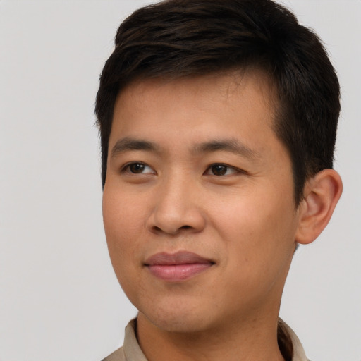 Joyful asian young-adult male with short  brown hair and brown eyes