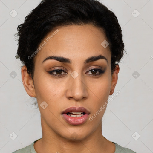 Joyful latino young-adult female with short  black hair and brown eyes