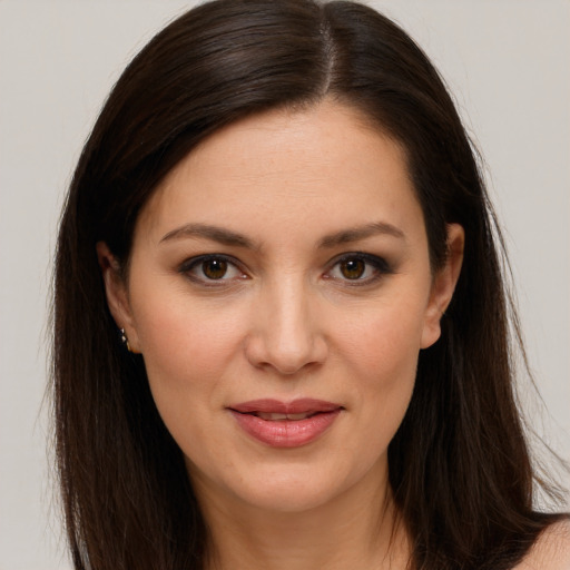 Joyful white young-adult female with long  brown hair and brown eyes