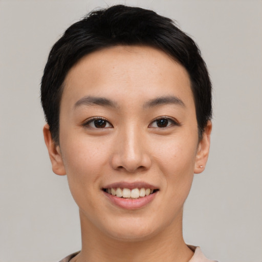 Joyful asian young-adult female with short  black hair and brown eyes