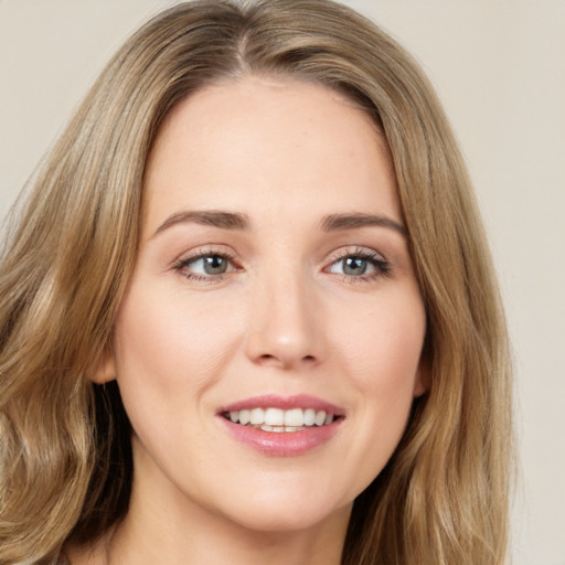 Joyful white young-adult female with long  brown hair and green eyes