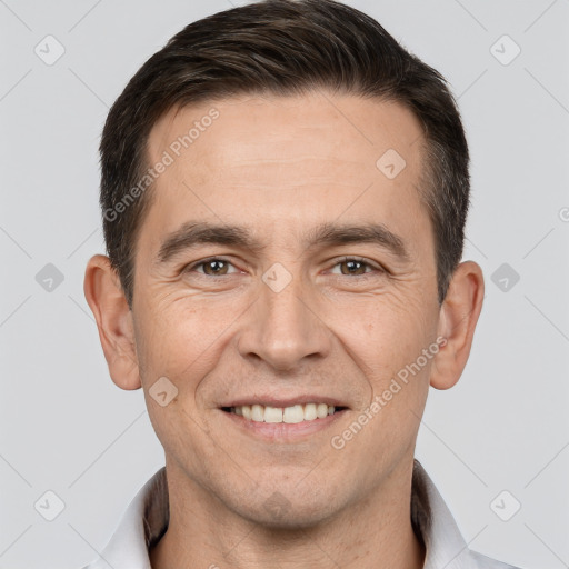 Joyful white adult male with short  brown hair and brown eyes