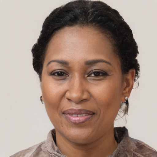 Joyful black adult female with short  black hair and brown eyes