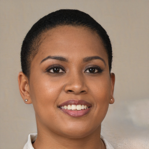 Joyful black young-adult female with short  brown hair and brown eyes