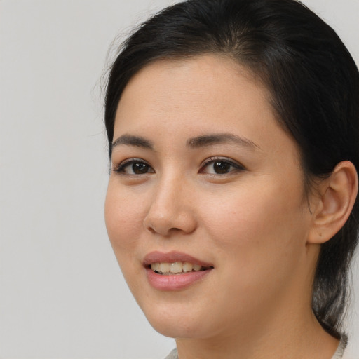 Joyful asian young-adult female with medium  brown hair and brown eyes