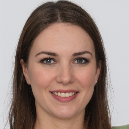 Joyful white young-adult female with long  brown hair and brown eyes