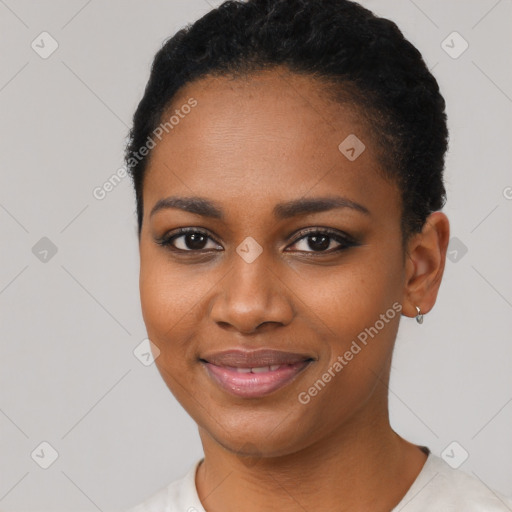 Joyful black young-adult female with short  black hair and brown eyes